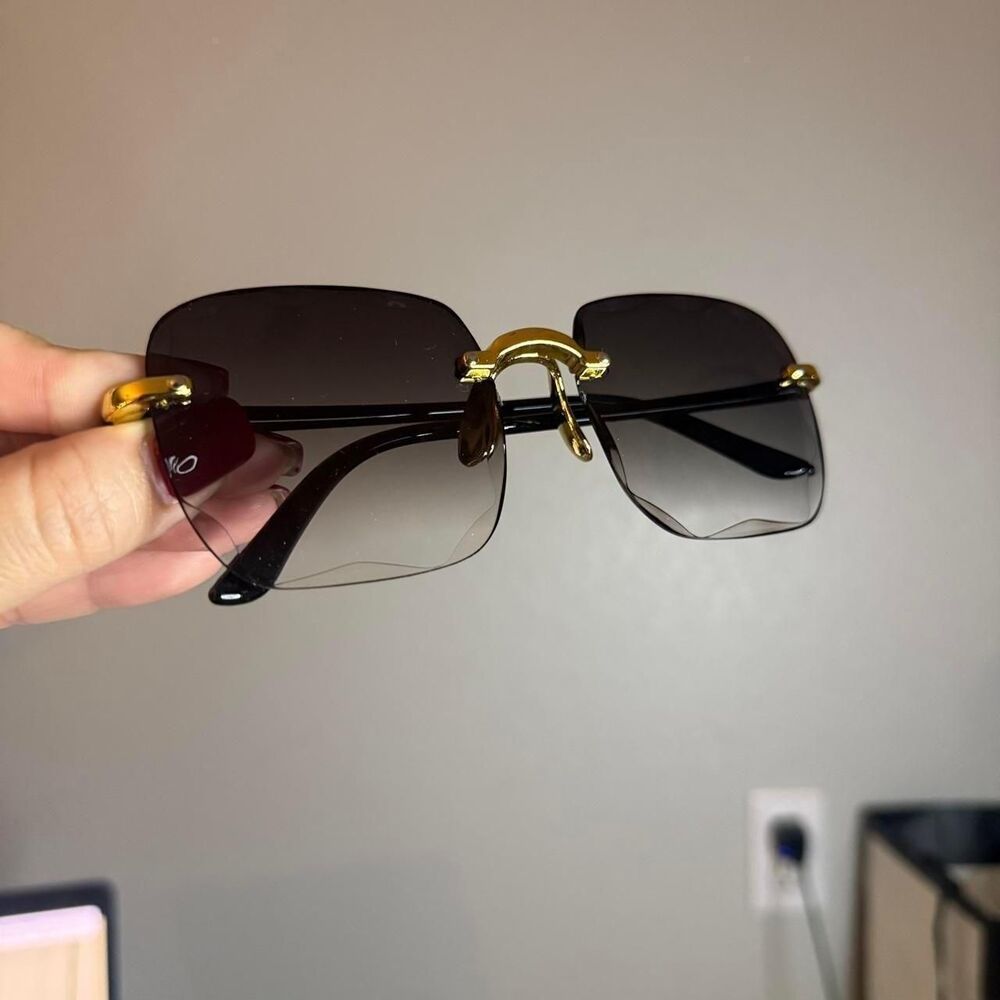 Rimless black and gold sunglasses
